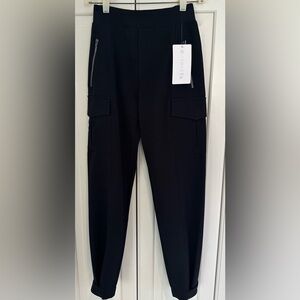 NWT Athleta Endless Cargo Black Pants. Size 0 
2 snaps on hem. Side zippers